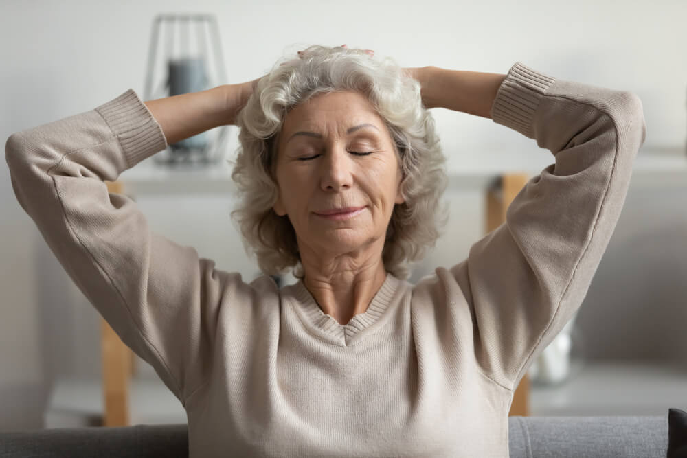 elderly women sitting with eyes closed 